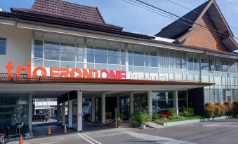 "a large building with the name "" room one "" prominently displayed , located on a busy city street" at Front One Resort Magelang