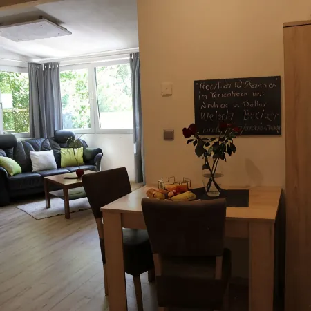Modernly Furnished Bungalow with Fireplace, Surrounded by Greenery.