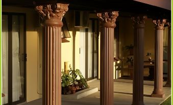 a row of decorative columns standing in front of a house , creating a traditional and elegant appearance at Mountain View Guest House