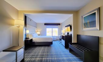 a hotel room with a king - sized bed , a flat - screen tv , and various pieces of furniture at Holiday Inn Belcamp - Aberdeen Area