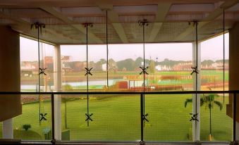 a view of a golf course through a window with fenced area in the foreground at The Retreat