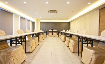 a large conference room with rows of chairs arranged in a semicircle , and a podium at the front of the room at Putatan Platinum Hotel