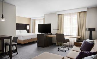 a modern hotel room with a bed , desk , chair , and tv , all arranged in a comfortable setting at Residence Inn Harrisburg Carlisle