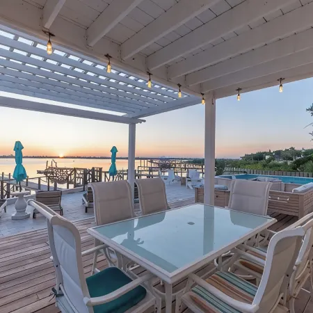 Waterfront home with dock, heated pool, & spectacular views- walk/bike downtown!
