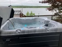 Spectacular lake view with a huge deck and a Hot Tub.