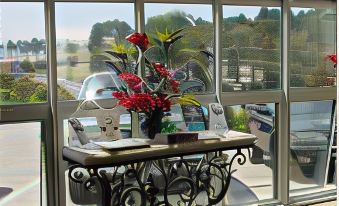 a living room with a large window overlooking the ocean , providing a beautiful view of the ocean at Malibu Country Inn