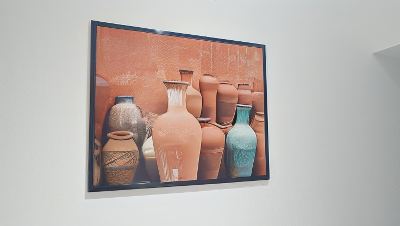 a framed picture of a collection of vases on a wall , surrounded by various objects at Vichy