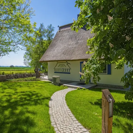 Picturesquely situated thatched-roof house in a large park-like garden