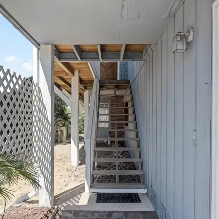 Located directly on canal w/ beautiful water front views — one block from beach