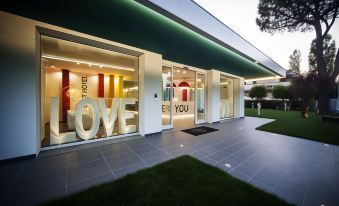 "a modern building with large letters spelling out the word "" love "" in front of it" at Love Boat Hotel - the Original