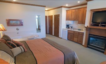 a clean and well - organized bedroom with a bed , a sink , and a kitchenette in the background at Scandinavian Lodge