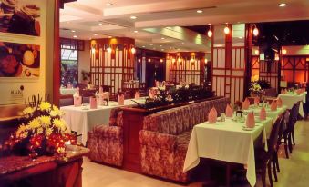 a dining room with several tables and chairs arranged for a group of people to enjoy a meal at Horison Ultima Bandung