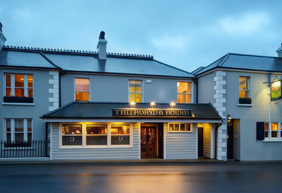 the exterior of the first fiorda 's corner pub , lit up with lights and inviting customers to enter at Horse & Hound