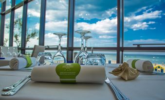 a table set for a meal with wine glasses and a white napkin on a napkin at San Marco