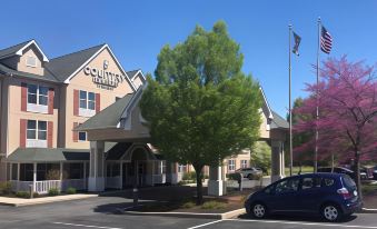 "a car is parked in front of a hotel with the sign "" campanile "" on it" at Country Inn & Suites by Radisson, Harrisburg Northeast - Hershey