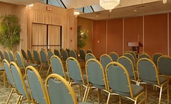 a conference room with rows of chairs arranged in a semicircle , and a podium at the front of the room at Days Inn by Wyndham Lanham Washington DC