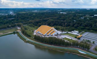 aerial view of a large building near a body of water , surrounded by trees and grass at Mammoth Resort