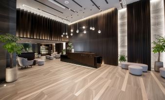 a modern lobby with a black and wood color scheme , featuring a reception desk and several potted plants at Boston Hotel