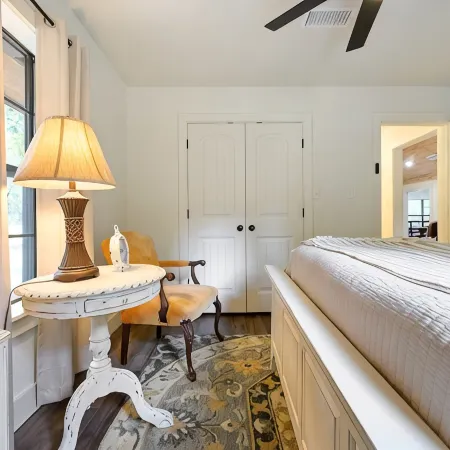 Secluded 4 bedroom farmhouse nestled on 8 acres with large lawn and oak trees.