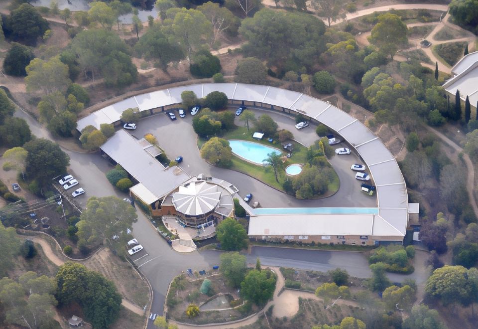 an aerial view of a large hotel with a pool and parking lot in the parking lot at Lyndoch Hill