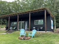 Charming shipping container home with lake view and boat ramp.