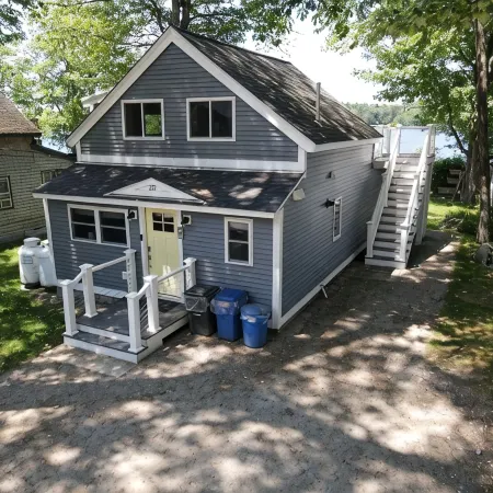 Relax in Raymond's lakefront 2-bedroom vacation home, just steps to Sebago Lake