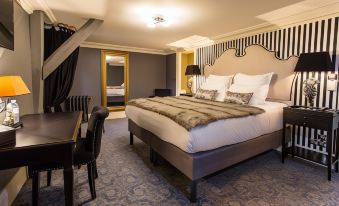 a large bed with a fur blanket is in the center of a room with blue and white carpeting at Hotel Vendome, BW Signature Collection