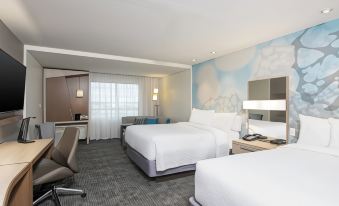a modern hotel room with two beds , a desk , and a chair , all neatly arranged at Courtyard Cleveland Elyria