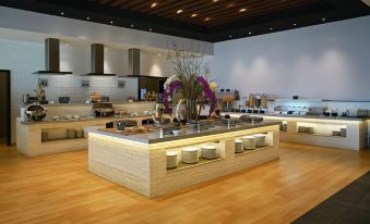 a large , modern dining area with a long buffet table filled with various dishes and utensils at Java Heritage Hotel Purwokerto