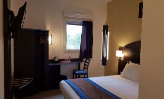 a hotel room with a large bed , desk , and window , providing a comfortable living space at Sure Hotel by Best Western St-Amand-Les-Eaux