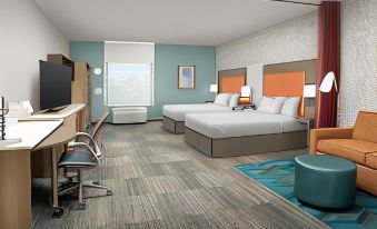 a hotel room with two beds , a desk , and a chair , all arranged in a modern style at Home2 Suites by Hilton Marysville