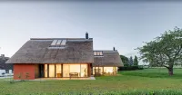 Thatched roof meets modernity, lake view; sauna, garden and much more...