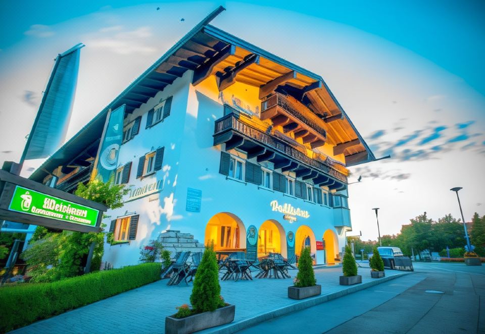 a large building with a blue facade and yellow windows is situated on a street at Hotel Bellevue