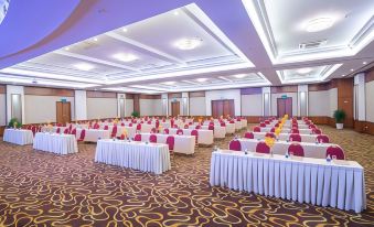 a large conference room filled with rows of tables and chairs , ready for a meeting or event at Palace Hotel