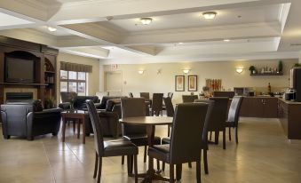 a large dining room with several tables and chairs arranged for a group of people to enjoy a meal together at Ramada by Wyndham High River