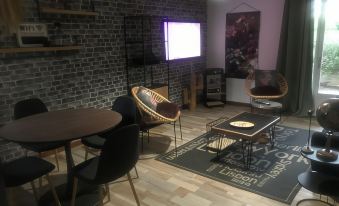 a modern living room with a brick wall , wooden floor , and various furniture items including chairs and a table at Marina