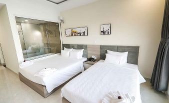 a hotel room with two beds , one on the left and one on the right side of the room at Lake View Hotel
