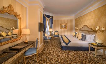 a luxurious hotel room with a king - sized bed , a flat - screen tv , and a comfortable seating area at Royal Rose Abu Dhabi, a Curio Collection by Hilton Affiliated Hotel