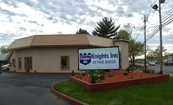 a small town with a knights inn of the berkshires sign in front of it at Knights Inn Pine Brook
