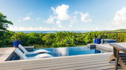 Tiny house on an acre with ocean view and private infinity pool.