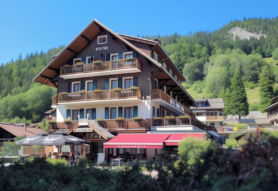 a large wooden building with a red awning , situated in a mountainous area surrounded by trees at Hotel Christiania