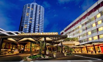 "At night, there is a building with the word ""hotel"" on it, both in front and behind" at Ambassador Hotel Bangkok