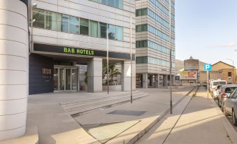 "a modern building with a sign that says "" bar hotels "" on the front , located in a city setting" at B&B Hotel Trapani Crystal