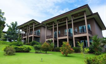 a large , modern building with multiple balconies and multiple balconies , surrounded by lush greenery and trees at Nakakiri Resort & Spa