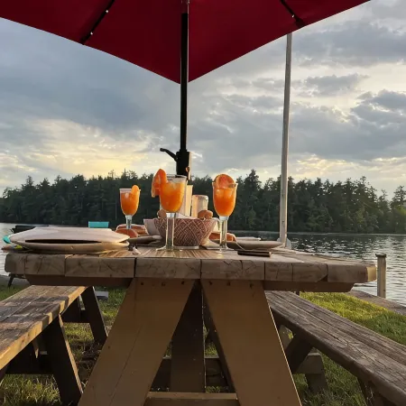 Stunning lakefront home with a boathouse, private dock, firepit and lake views