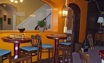 a dining area with a wooden table and chairs , as well as a staircase in the background at Thayers Inn