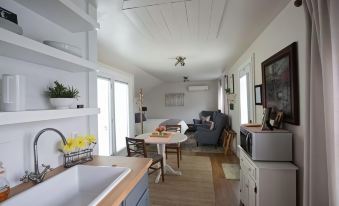 a cozy living room with a couch , chairs , and a dining table in the background at Country View PA Bed & Breakfast