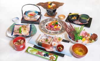 a dining table with a variety of food items , including bowls , cups , and utensils , arranged in an elegant manner at Furano la Terre