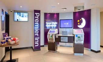 "a hotel lobby with a check - in desk and a sign that reads "" premier inn "" prominently displayed" at Thirsk