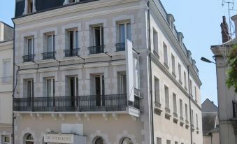 a three - story building with a white exterior and black balconies is situated on a street corner at Hotel Vendome, BW Signature Collection